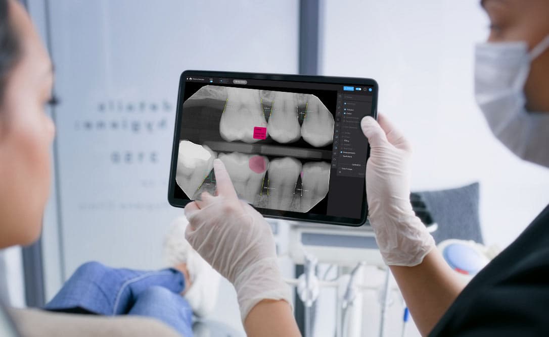 Oryx Dental - Our Roots Photo of dentist and dental assistant reviewing X-ray