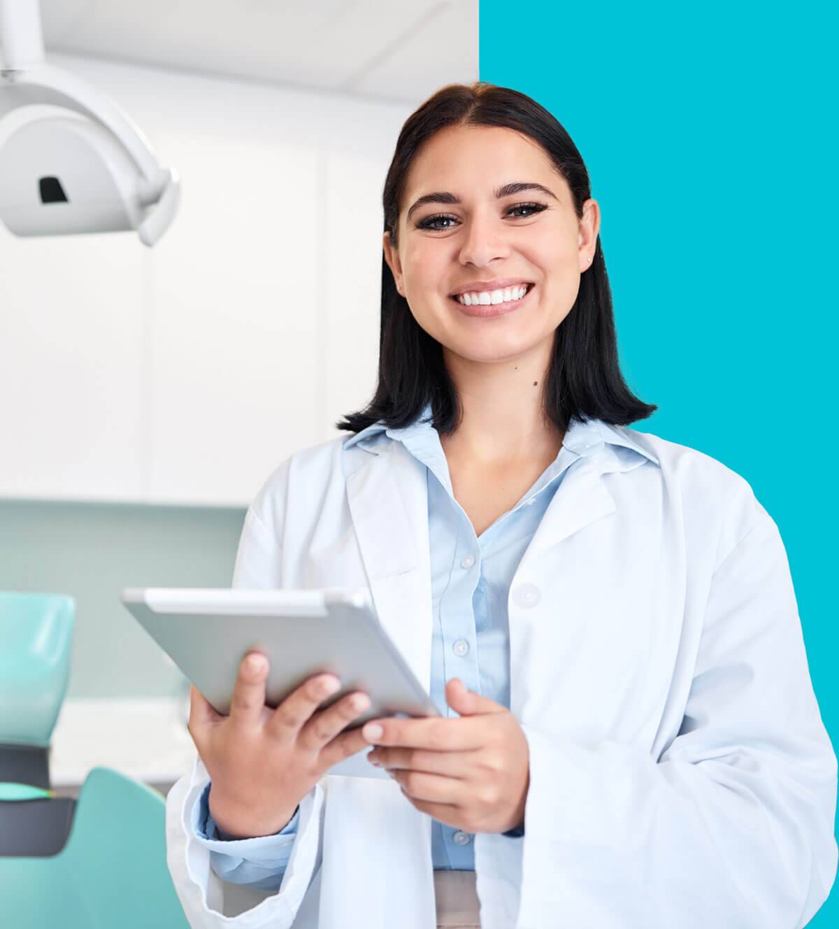 Happy female dentist holding an iPad.